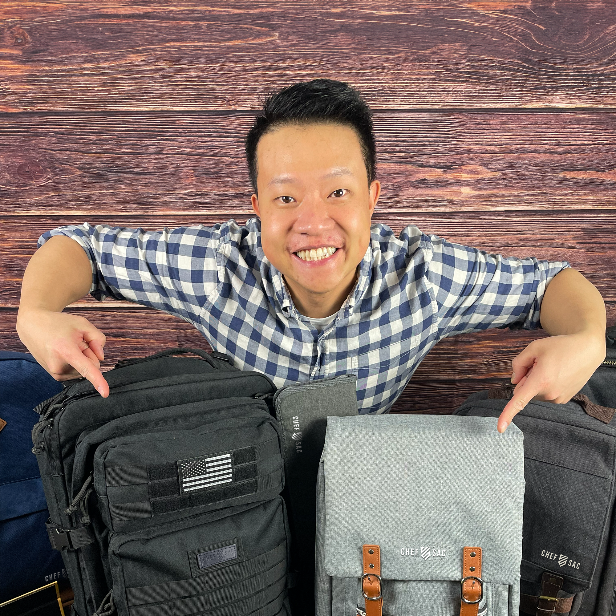 'Chef Sac' founder Keith Chiu pointing at various chef backpacks