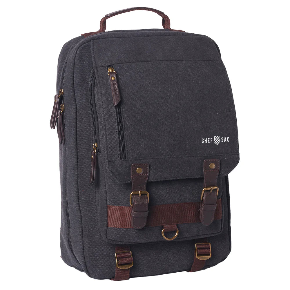 washed black canvas backpack with visible branding 'Chef Sac' with brown straps accents on a white background 
